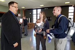 A prospective student and his wife visit with Dr. Ryan Tietz over coffee hour during the Prayerfully Consider Visit.