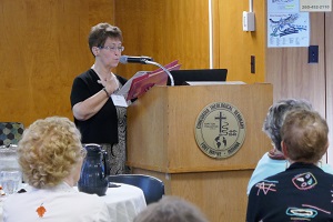 Phyllis Thieme, president of the guild, addresses the Donation Day visitors.