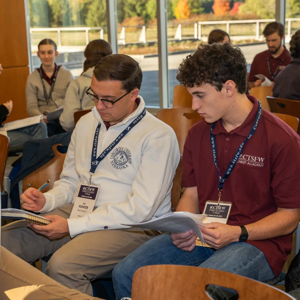 A speaker leads a class session for a room full of college students.