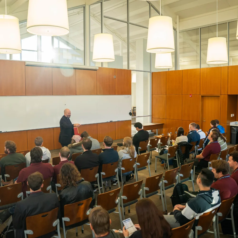 College students smile and talk during a session.